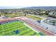 An aerial shot presents the athletic fields, stadium seating, and running track of Willow Canyon High School at 18072 W Paradise Ln, Surprise, AZ 85388