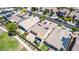 Aerial view of a home with solar panels, desert landscaping, a gazebo, and backyard next to a green space at 18072 W Paradise Ln, Surprise, AZ 85388