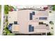 An aerial view of a tile roof of a home featuring solar panels and desert landscaping with colorful flowers and shrubbery at 18072 W Paradise Ln, Surprise, AZ 85388