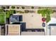 An aerial view of the backyard with desert landscaping, a gazebo, a shed, and greenery along the back wall at 18072 W Paradise Ln, Surprise, AZ 85388