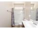 Bathroom with a shower-tub combo, grab bar and single sink vanity at 18072 W Paradise Ln, Surprise, AZ 85388