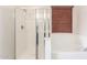 Bright bathroom featuring a tiled shower and a separate soaking tub with a window at 18072 W Paradise Ln, Surprise, AZ 85388