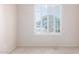 Bedroom featuring carpet, a large window with shutters, and neutral paint at 18072 W Paradise Ln, Surprise, AZ 85388