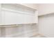 Walk-in closet featuring wood shelving and a clothes bar at 18072 W Paradise Ln, Surprise, AZ 85388