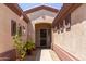 Inviting entryway featuring beautiful plants, desert landscaping, and textured exterior walls at 18072 W Paradise Ln, Surprise, AZ 85388