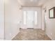 Bright foyer with tile flooring, neutral walls, and a welcoming front door at 18072 W Paradise Ln, Surprise, AZ 85388