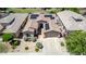 Charming single-story home featuring a desert landscape, a two-car garage, and solar panels at 18072 W Paradise Ln, Surprise, AZ 85388