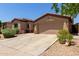 Charming home with a two-car garage, tidy landscaping, and a neutral color palette, with the address 18072 displayed at 18072 W Paradise Ln, Surprise, AZ 85388