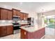 Updated kitchen featuring stainless appliances, a tile backsplash, and updated countertops at 18072 W Paradise Ln, Surprise, AZ 85388
