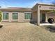 Wide backyard featuring desert landscaping, covered patio, and clear blue skies at 18207 W Marshall Ln, Surprise, AZ 85388