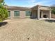 Backyard with a covered patio, low-maintenance rock landscaping, and desert plants at 18207 W Marshall Ln, Surprise, AZ 85388