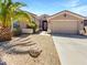 Charming home featuring a two-car garage, well-manicured desert landscaping, and beautiful curb appeal at 18207 W Marshall Ln, Surprise, AZ 85388