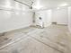 Spacious garage with concrete flooring, white walls, water heater, and storage space at 18207 W Marshall Ln, Surprise, AZ 85388