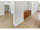 Hallway with built-in cabinet space and views to the laundry room on tile flooring at 18207 W Marshall Ln, Surprise, AZ 85388