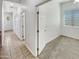 Hallway with tile flooring, neutral paint, and ample natural light leading to the bedrooms at 18207 W Marshall Ln, Surprise, AZ 85388