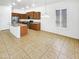 Open-concept kitchen with a central island, wood cabinets, stainless steel appliances, and tiled floors at 18207 W Marshall Ln, Surprise, AZ 85388