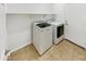 Efficient laundry room featuring a top-load washer, dryer, and built-in shelving for added storage at 18207 W Marshall Ln, Surprise, AZ 85388