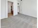 Bright living room with carpet flooring, white walls, and access to other rooms at 18207 W Marshall Ln, Surprise, AZ 85388