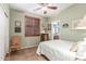 Cozy bedroom with plantation shutters, tiled flooring, and a view into the bathroom at 18482 W Marconi Ave, Surprise, AZ 85388