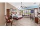 Serene bedroom featuring neutral tones, tile flooring, and multiple windows for natural light at 18482 W Marconi Ave, Surprise, AZ 85388