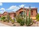 Southwest-style home with desert landscaping, including mature cacti and decorative rock, enhancing curb appeal at 18482 W Marconi Ave, Surprise, AZ 85388