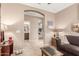 Neutral hallway with an archway leading to rooms with beige walls and tiled floors at 18482 W Marconi Ave, Surprise, AZ 85388