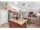 Open concept kitchen with stainless steel appliances, central island and seamless flow into the living space at 18482 W Marconi Ave, Surprise, AZ 85388