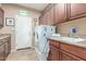 Laundry room with cabinets, sink, and modern washer and dryer units at 18482 W Marconi Ave, Surprise, AZ 85388