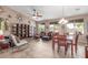An open-concept living room with neutral tones, tile flooring, ceiling fan and several windows at 18482 W Marconi Ave, Surprise, AZ 85388