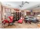 Living room and kitchen featuring tile floors, a ceiling fan and recessed lighting, with access to the kitchen at 18482 W Marconi Ave, Surprise, AZ 85388