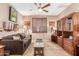 Inviting living room with a comfortable brown sofa, wood accents and neutral color palette at 18482 W Marconi Ave, Surprise, AZ 85388