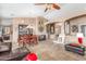 Open living room with tile floors featuring a coffered ceiling, dining set, and comfortable seating at 18482 W Marconi Ave, Surprise, AZ 85388