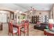 View of an open-concept living room featuring tile floors, chandelier, and a coffered ceiling at 18482 W Marconi Ave, Surprise, AZ 85388