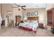 Comfortable main bedroom features a ceiling fan, ample natural light and neutral decor at 18482 W Marconi Ave, Surprise, AZ 85388