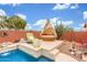 Inviting pool area with a unique lounge pod and a comfortable chair for relaxing in the backyard at 18482 W Marconi Ave, Surprise, AZ 85388