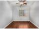 Empty bedroom with hardwood floors, ceiling fan, a window with blinds, and neutral colored walls at 18775 E Seagull Dr, Queen Creek, AZ 85142