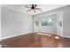 Light-filled bedroom with hardwood floors and a ceiling fan at 18775 E Seagull Dr, Queen Creek, AZ 85142