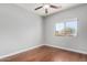 Bedroom featuring dark hardwood floors, a ceiling fan, natural light, and neutral-colored walls at 18775 E Seagull Dr, Queen Creek, AZ 85142