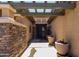 Welcoming covered entry featuring stacked stone accents and decorative potted plants at 18775 E Seagull Dr, Queen Creek, AZ 85142