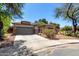 Charming single-story home with a gray two-car garage, well-maintained landscaping, and a concrete driveway at 18775 E Seagull Dr, Queen Creek, AZ 85142