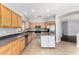Well-lit kitchen with stainless steel appliances, center island and light wood cabinetry at 18775 E Seagull Dr, Queen Creek, AZ 85142