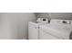 Laundry room featuring a modern top-load washer and dryer combination set against light gray walls at 18775 E Seagull Dr, Queen Creek, AZ 85142