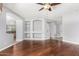 Spacious living room with hardwood floors, a ceiling fan, and built-in shelving at 18775 E Seagull Dr, Queen Creek, AZ 85142