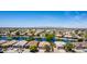 Panoramic aerial shot of a community with homes nestled around a tranquil lake, highlighting the neighborhood layout at 19942 N 108Th Ave, Peoria, AZ 85373
