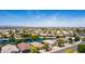 Expansive aerial view of a Primary-planned community showcasing its serene lake and well-maintained residential streets at 19942 N 108Th Ave, Peoria, AZ 85373