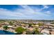 Expansive aerial view of a residential neighborhood featuring numerous homes surrounding a picturesque lake at 19942 N 108Th Ave, Peoria, AZ 85373