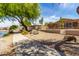 Well-maintained backyard with desert landscaping and scenic waterfront views, perfect for outdoor enjoyment at 19942 N 108Th Ave, Peoria, AZ 85373