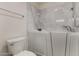 The bathroom showcases a walk-in tub with safety features, complemented by a nearby toilet at 19942 N 108Th Ave, Peoria, AZ 85373