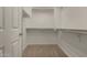 Walk-in closet with multiple shelves and racks for optimal storage solutions at 19942 N 108Th Ave, Peoria, AZ 85373