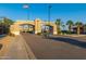 Elegant community entrance showcasing 'The Landings Ventana Lakes' with palm trees and well-kept landscaping at 19942 N 108Th Ave, Peoria, AZ 85373